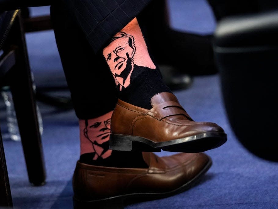 Judge Ketanji Brown Jackson's husband Dr. Patrick Jackson wears pink socks with the likeness of John F. Kennedy to her confirmation hearings