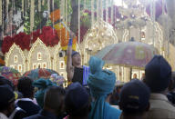 The groom's procession arrives at the house of Reliance Industries Chairman Mukesh Ambani in Mumbai, India, Wednesday, Dec. 12, 2018. In a season of big Indian weddings, the Wednesday marriage of the scions of two billionaire families might be the biggest of them all. The bride, Isha Ambani, is the Ivy League-educated daughter of industrialist Mukesh Ambani, thought to be India's richest man. Forbes estimates his net worth at over $43 billion. The groom is the son of industrialist Ajay Piramal, thought to be worth $10 billion. (AP Photo/Rajanish Kakade)