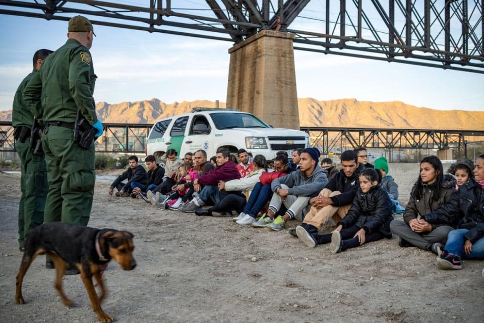 <div class="inline-image__caption"><p>A group of about 30 Brazilian migrants, who had just crossed the border, sit on the ground near US Border Patrol agents on the US-Mexico border in Sunland Park, New Mexico.</p></div> <div class="inline-image__credit">Paul Ratje / AFP via Getty Images</div>