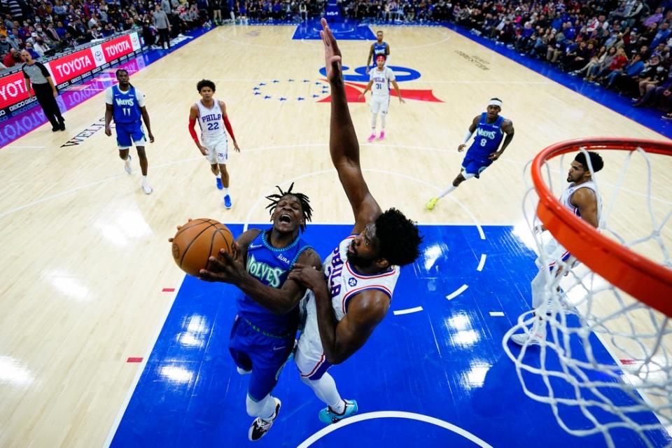 Minnesota Timberwolves’ Anthony Edwards, left, tries to get a shot past Philadelphia 76ers’ Joel Embiid (Matt Slocum/AP) (AP)