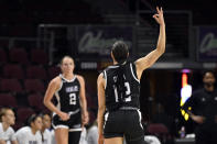 Stephen F. Austin guard Kyla Deck (12) reacts after 3-point basket by guard Tyler McCliment-Call (2) during the first half of an NCAA college basketball game against California Baptist in the championship of the Western Athletic Conference women's tournament Saturday, March 16, 2024, in Las Vegas. (AP Photo/David Becker)