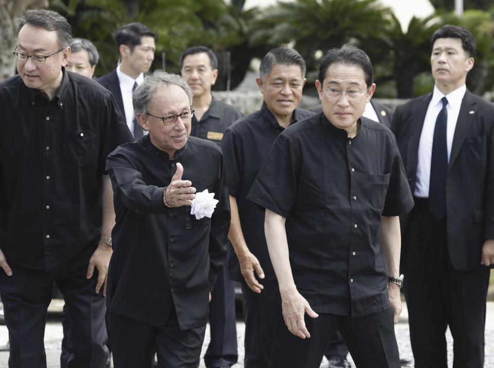 Japan's Prime Minister Fumio Kishida, front right, is escorted by Okinawa Gov. Denny Tamaki as they visit the cemetery for the war dead at the Peace Memorial Park in Itoman, Okinawa prefecture, southern Japan Friday, June 23, 2023. Japan marked the Battle of Okinawa, one of the bloodiest battles of World War II fought on the southern Japanese island, which ended 78 years ago. (Kyodo News via AP)