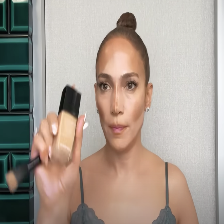 J.Lo applying makeup