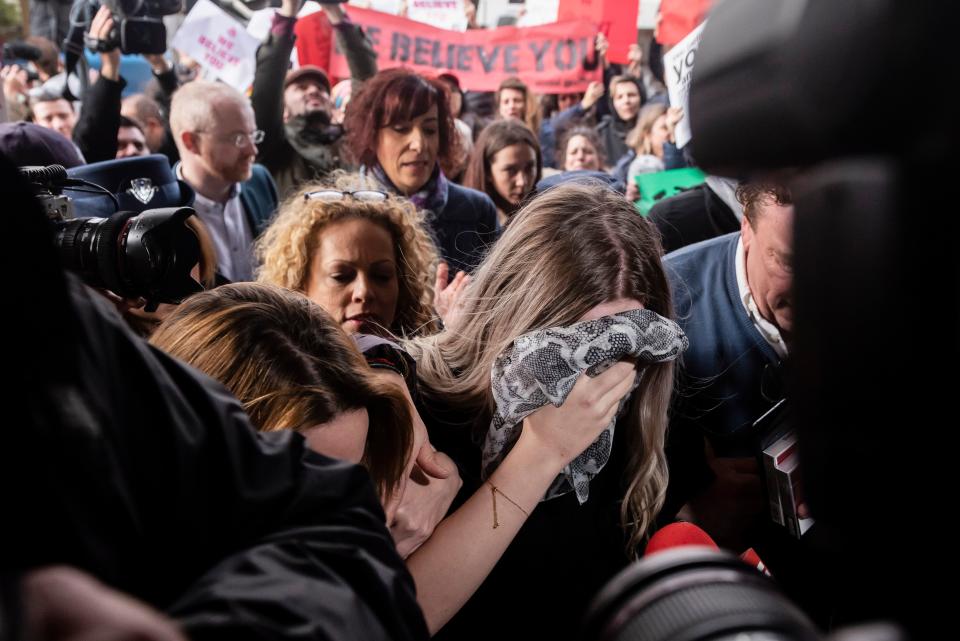 A British teenager, convicted of falsely accusing a group of Israelis of gang-rape, covers her face as she arrives at the Famagusta District Court in Paralimni in eastern Cyprus on January 7, 2020. - The 19-year-old was found guilty last week and could face up to a year in jail, after what her defence team blasted as a litany of rights failings by Cypriot authorities. (Photo by Iakovos HATZISTAVROU / AFP) (Photo by IAKOVOS HATZISTAVROU/AFP via Getty Images)