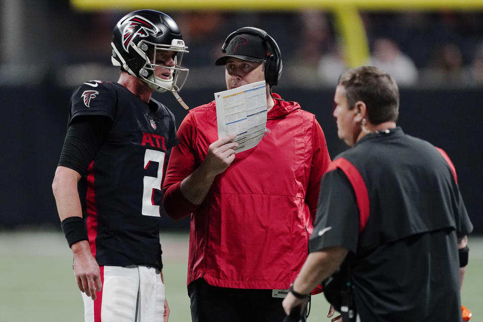 Atlanta Falcons head coach Arthur Smith speaks with Atlanta Falcons quarterback Matt Ryan (2) during the first half of an NFL football game against the Tampa Bay Buccaneers, Sunday, Dec. 5, 2021, in Atlanta. (AP Photo/John Bazemore)