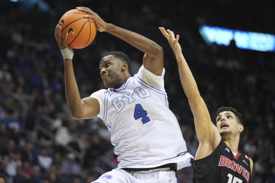 BYU forward Atiki Ally Atiki dives to the basket past Denver forward Pedro Lopez-Sanvicente during game Wednesday, Dec. 13, 2023, in Provo, Utah. | George Frey, Associated Press