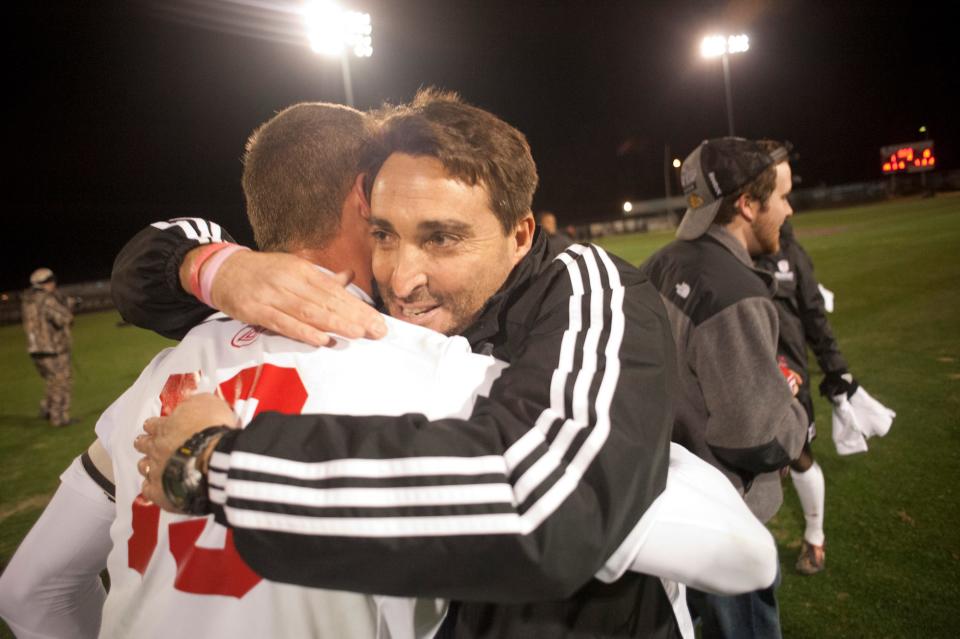 Bradley's head coach Jim DeRose, right, embraces forward Wojciech Wojcik (19) Sunday night at Shea Stadium after the win at the Missouri Valley Conference men's soccer championship game. Bradley defeated Missouri State, 1-0.