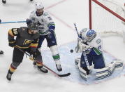 Vancouver Canucks goalie Thatcher Demko (35) makes a save as Vegas Golden Knights' Paul Stastny (26) and Canucks' Alexander Edler (23) look for a rebound during the third period of Game 5 of an NHL hockey second-round playoff series, Tuesday, Sept. 1, 2020, in Edmonton, Ontario. (Jason Franson/The Canadian Press via AP)