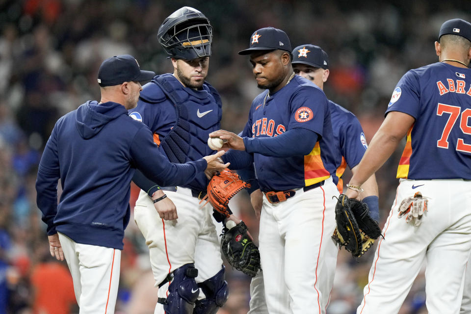 Houston Astros starting pitcher Framber Valdez, center, hands the ball to manager Joe Espada while being removed during the eighth inning of the team's baseball game against the Toronto Blue Jays, Tuesday, April 2, 2024, in Houston. (AP Photo/Eric Christian Smith)