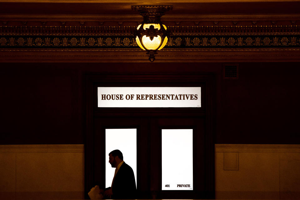 FILE - In this Nov. 20, 2019 file photo, a lawmaker is silhouetted as he walks past a window in the Pennsylvania Capitol in Harrisburg, Pa. While most states have not yet considered law changes to screen former clergy members who seek licenses for jobs that put them in contact with children, at least 20 state attorneys general are conducting investigations of how church officials handled abuse allegations, including reporting them to civil law enforcement, largely in the wake of the Pennsylvania attorney general office’s 2018 grand jury report that looked at how abuse allegations were handled in six dioceses. (AP Photo/Matt Rourke, File)