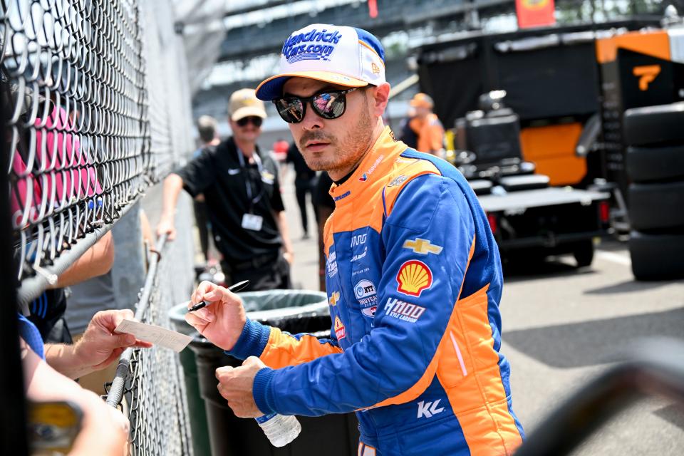 Arrow McLaren/Rick Hendrick driver Kyle Larson (17) signs autographs Monday, May 20, 2024, during practice for the 108th running of the Indianapolis 500 at Indianapolis Motor Speedway.
