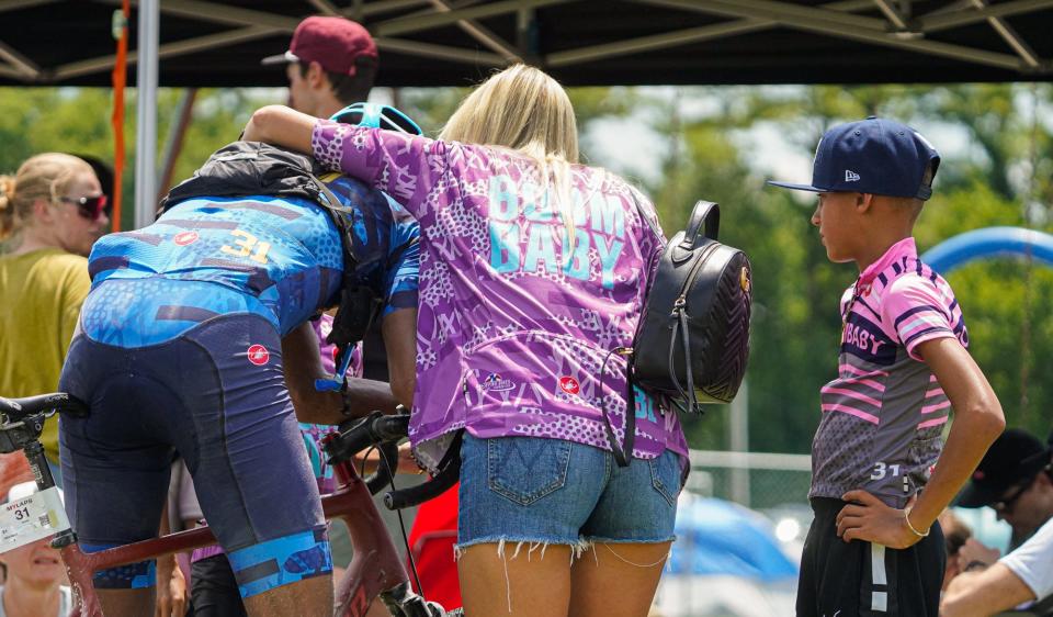 Retired Indiana Pacers player Reggie Miller, left, gets hugs and kisses from his wife Laura, center, his son Ryker, right, and daughter Lennox, (not visible) after completing the Dustbowl 100 gravel bicycle race on Saturday, July 22, 2023, in Eminence Ind.