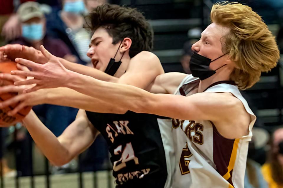 ROWVA/Williamsfield senior Carson Malek, right, battles Stark County's Luke Rewerts for a rebound during the Cougars' 53-35 win over the Rebels on Friday, Jan. 21, 2022 at ROWVA High School.