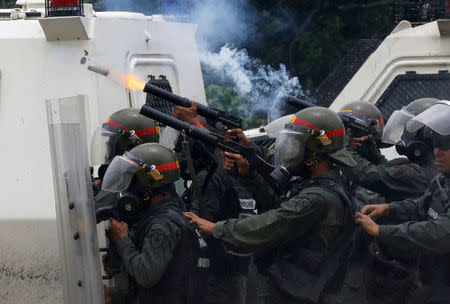 Riot police fire tear gas while clashing with opposition supporters rallying against President Nicolas Maduro in Caracas, Venezuela May 3, 2017. REUTERS/Carlos Garcia Rawlins