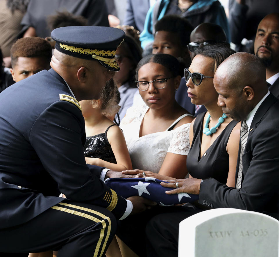 The folded American Flag is presented to West Point Cadet Christopher J. Morgan's parents, April and Christopher by Superintendent Darryl Williams, during the interment ceremony at West Point, N.Y., Saturday, June 15, 2019. Over 1500 family, friends and military personnel attended, as well as former President Bill Clinton who delivered remarks at the memorial service. (Mark Vergari/The Journal News via AP)