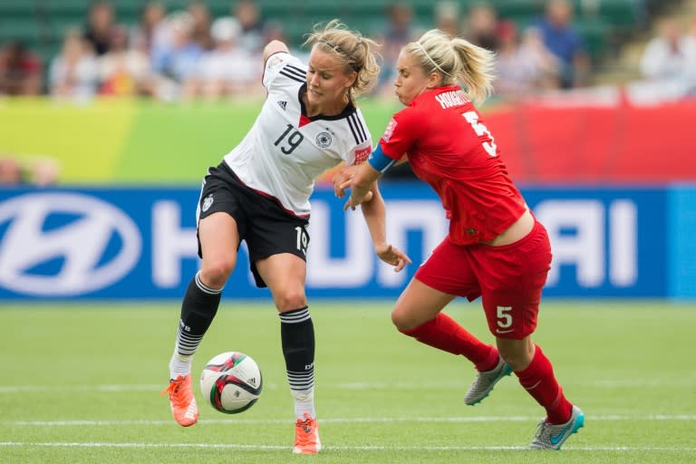 Germany's Lena Petermann (L) keeps the ball from England's Steph Houghton during the bronze medal match at the FIFA Women's World Cup in Edmonton, Canada on July 4, 2015