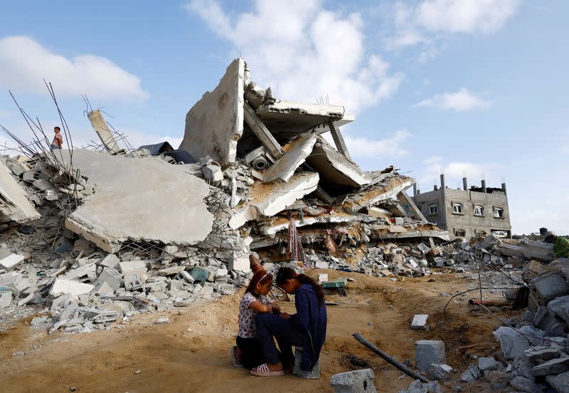 FILE PHOTO: Palestinian children sit next to the site of an Israeli strike on a house, in Rafah