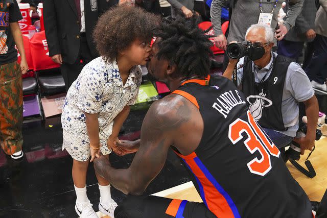 <p>Eric Espada/Getty</p> Julius Randle #30 of the New York Knicks gives his son Kyden a kiss after his team defeated the Miami Heat in March 2023.