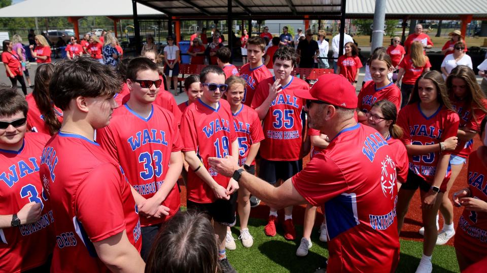 Wall players meet with their coach during game against Toms River East Unified at the Toms River Field of Dreams Tuesday, May 16, 2023.