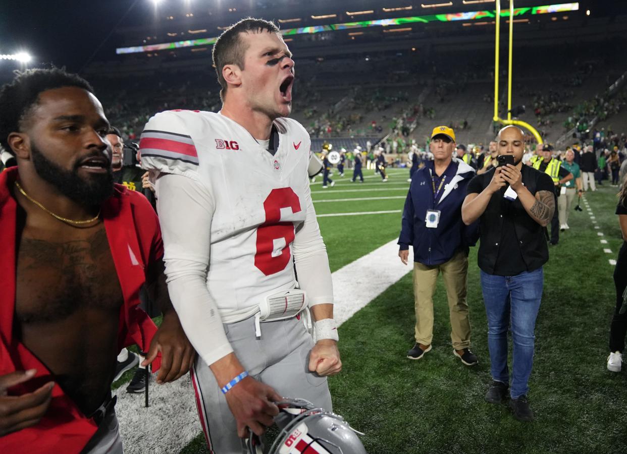 Ohio State quarterback Kyle McCord celebrates after beating Notre Dame on Saturday.