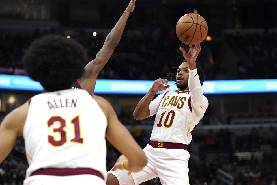 Cleveland Cavaliers' Darius Garland (10) passes to Jarrett Allen during the first half of the team's NBA basketball game against the Chicago Bulls on Wednesday, Jan. 19, 2022, in Chicago. (AP Photo/Charles Rex Arbogast)