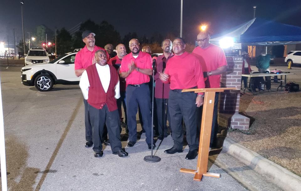 The Male Choir at Beauty Spot Missionary Baptist Church sings during a ceremony, during which church members switched on lights for a 10-foot angel on Saturday, Dec. 2, 2023.