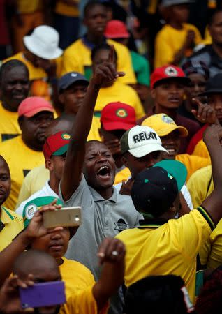 Supporters of various political parties cheer as farmers Willem Oosthuizen and Theo Martins are sentenced for kidnap, assault and attempted murder, in connection with forcing a man into a coffin, in Middelburg, South Africa, October 27, 2017. REUTERS/Siphiwe Sibeko