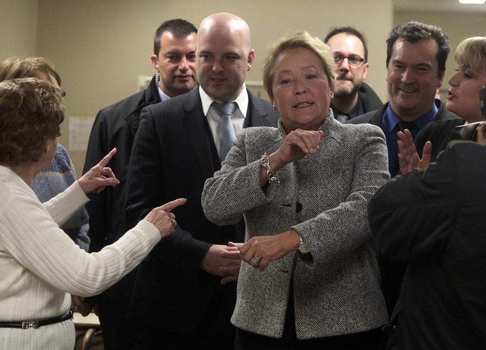 Parti Quebecois leader Pauline Marois reacts after throwing sandbags during a campaign stop in Longueuil