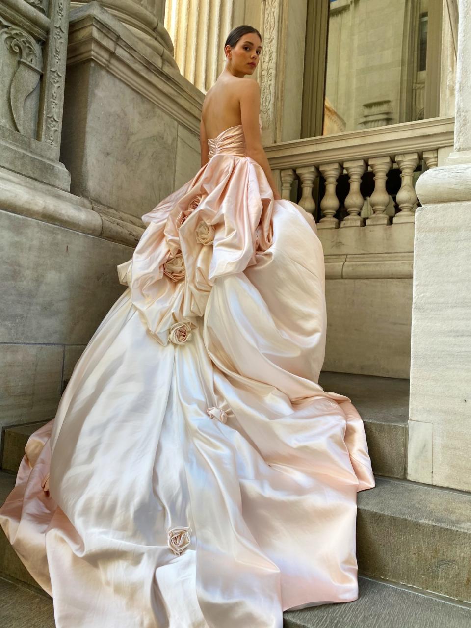 <p>Meet "Rose," the next-level ball gown with ombré satin, hand-tufted bustles, and hand-rolled rosettes that just bloomed straight out of <a href="https://moniquelhuillier.com/" rel="nofollow noopener" target="_blank" data-ylk="slk:Monique Lhuillier;elm:context_link;itc:0;sec:content-canvas" class="link ">Monique Lhuillier</a>'s Spring 2022 bridal collection. The gown is an embodiment of the designer's inspiration well, she tells us: "It reflects my current state of mind—I'm full of optimism, joy and gratitude and embracing the opening up of the world. Life is so precious—it should be celebrated to the fullest!"</p>