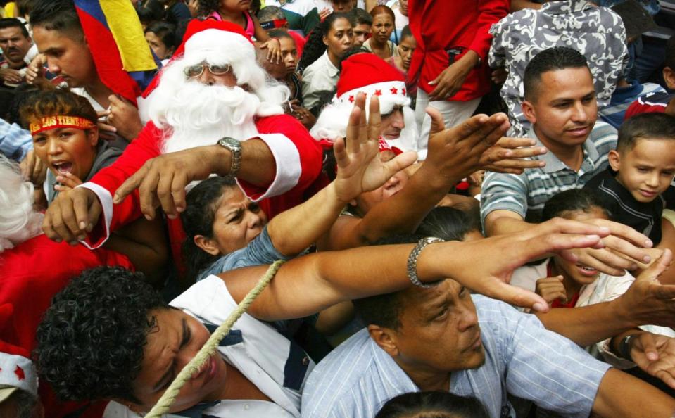 Huge crowds gather in Caracas, Venezuela, to receive presents from Santa Claus. (Getty Images)