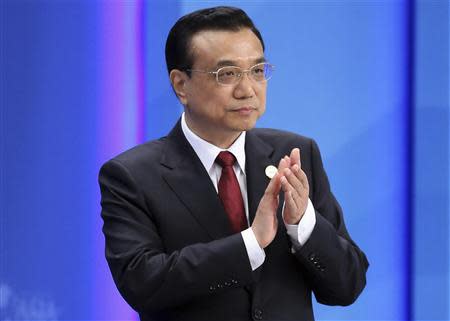 Chinese Premier Li Keqiang claps as he attends the opening ceremony of the Boao Forum for Asia (BFA) Annual Conference 2014 in Boao, Hainan province April 10, 2014. REUTERS/China Daily