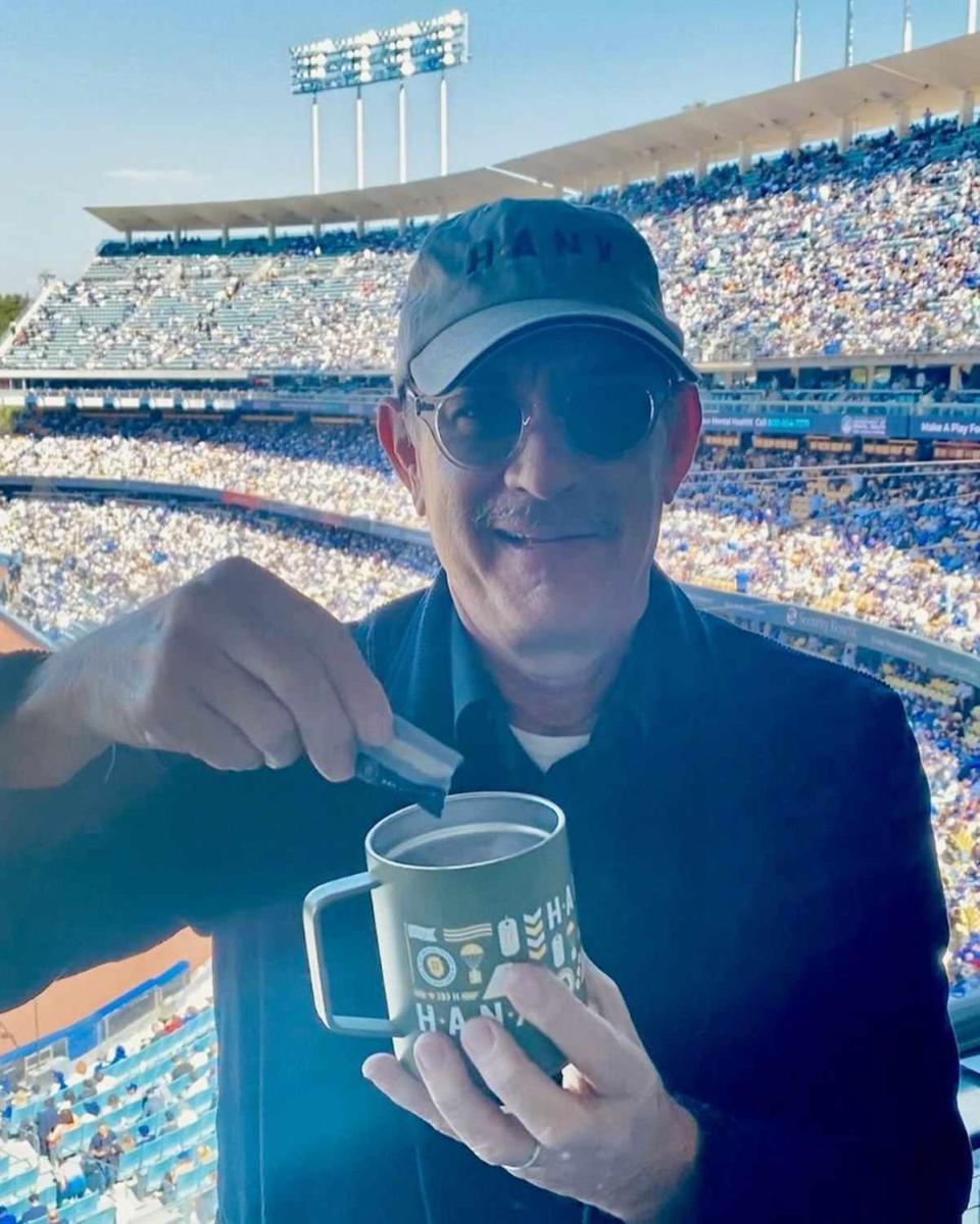 <p>Tom Hanks/Instagram</p> Tom Hanks brought his own Hanx coffee to a baseball game