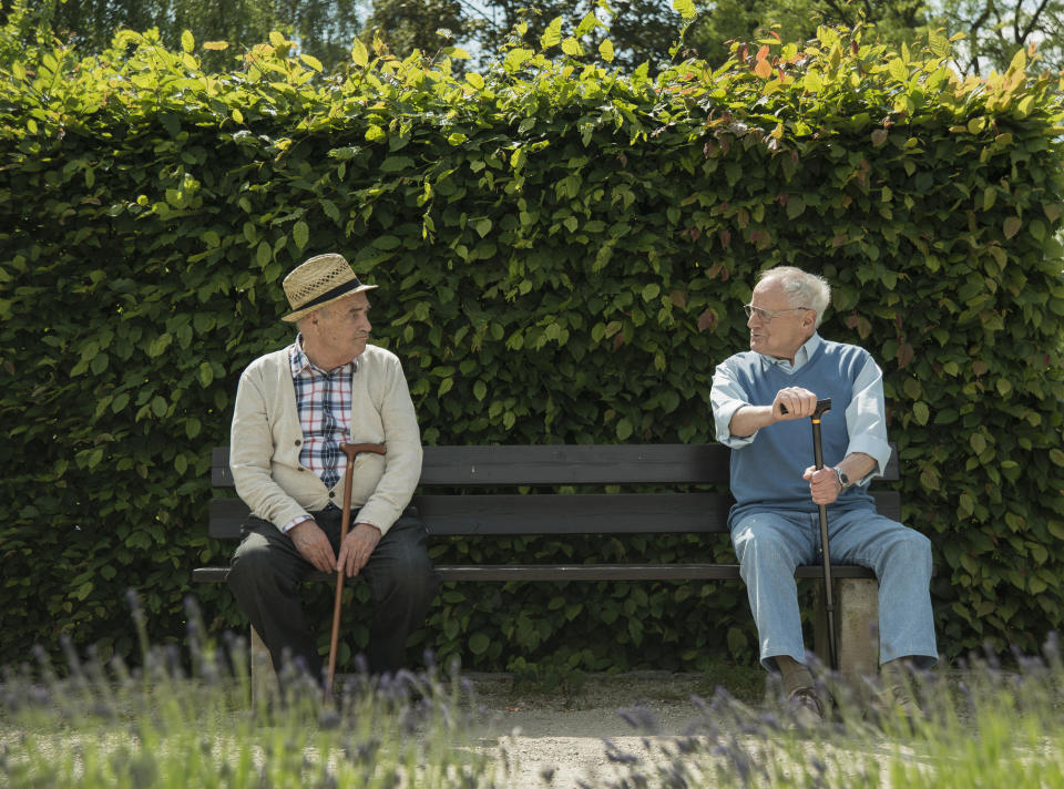Two men sitting on a park bench