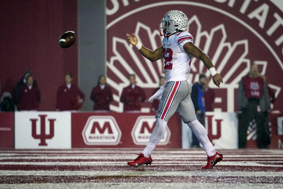 Ohio State running back TreVeyon Henderson (32) flips the ball after scoring a touchdown against Indiana in the first half during an NCAA college football game in Bloomington, Ind., Saturday, Oct. 23, 2021. (AP Photo/AJ Mast)