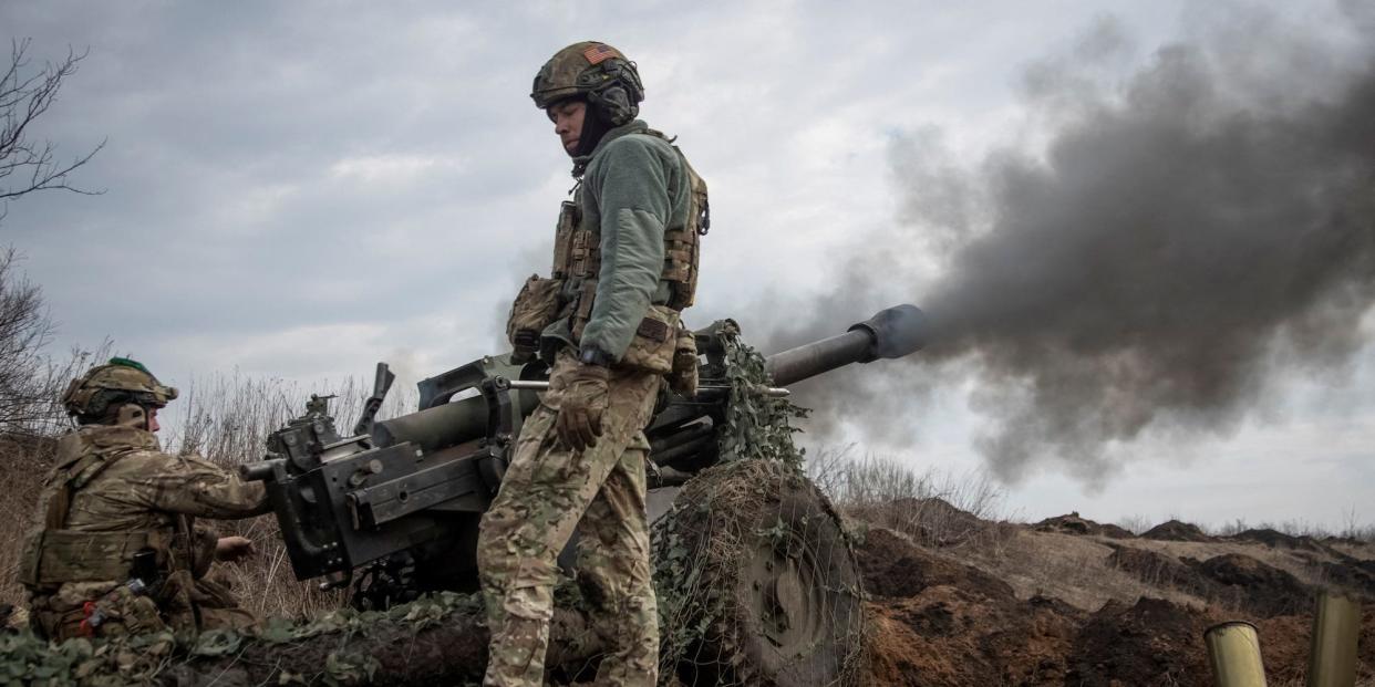 Ukrainian service members fire a howitzer M119 at a front line, amid Russia's attack on Ukraine, near the city of Bakhmut, Ukraine March 10, 2023.