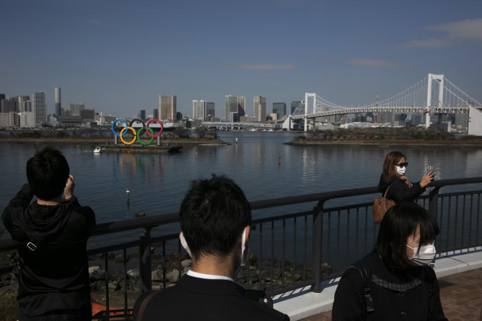 Tourists take pictures of the Olympics rings Monday, Feb. 24, 2020, in the Odaiba section of Tokyo. (AP Photo/Jae C. Hong)