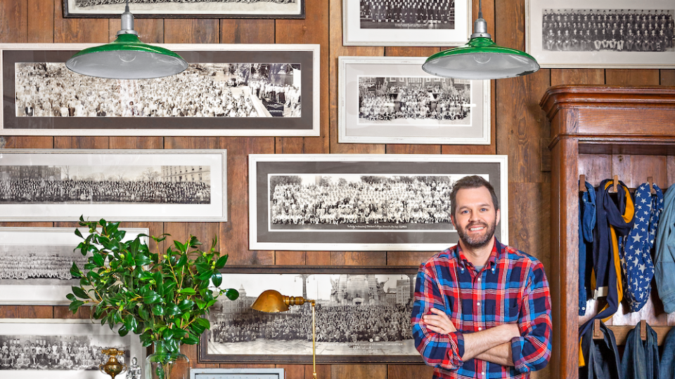 black and white team portraits are displayed on a gallery wall