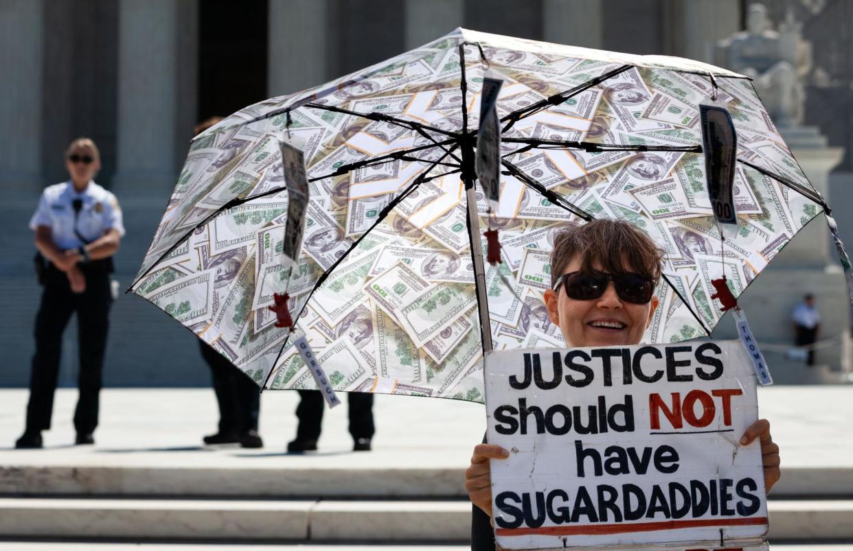 <span>A protester on 1 July 2024 in front of the US supreme court building.</span><span>Photograph: Allison Bailey/NurPhoto/Rex/Shutterstock</span>