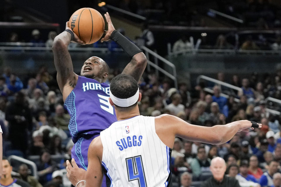 Charlotte Hornets guard Terry Rozier (3) takes a shot over Orlando Magic guard Jalen Suggs (4) during the second half of an NBA basketball game, Sunday, Nov. 26, 2023, in Orlando, Fla. (AP Photo/John Raoux)