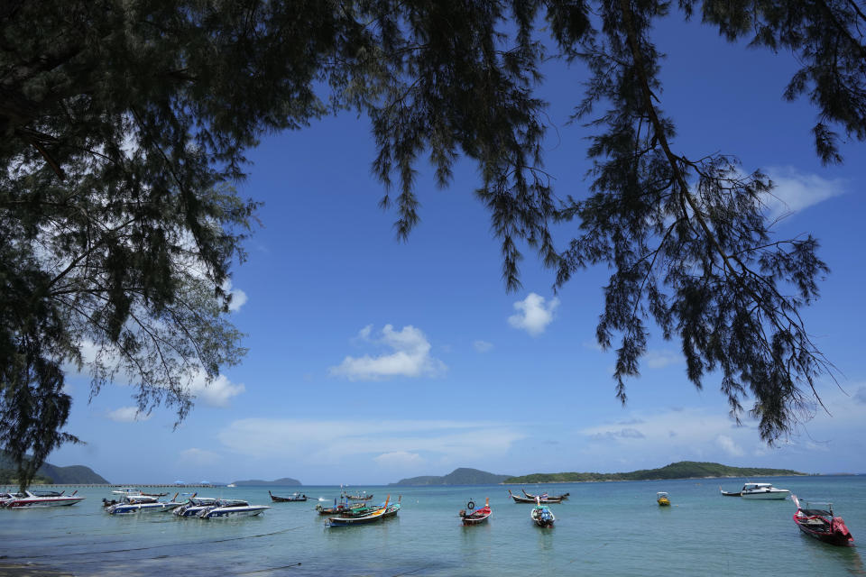 Empty tourist boats anchor off Rawai Beach on Phuket, southern Thailand, Monday, June 28, 2021. Thailand's government will begin the "Phuket Sandbox" scheme to bring the tourists back to Phuket starting July 1. Even though coronavirus numbers are again rising around the rest of Thailand and prompting new lockdown measures, officials say there's too much at stake not to forge ahead with the plan to reopen the island to fully-vaccinated travelers. (AP Photo/Sakchai Lalit)