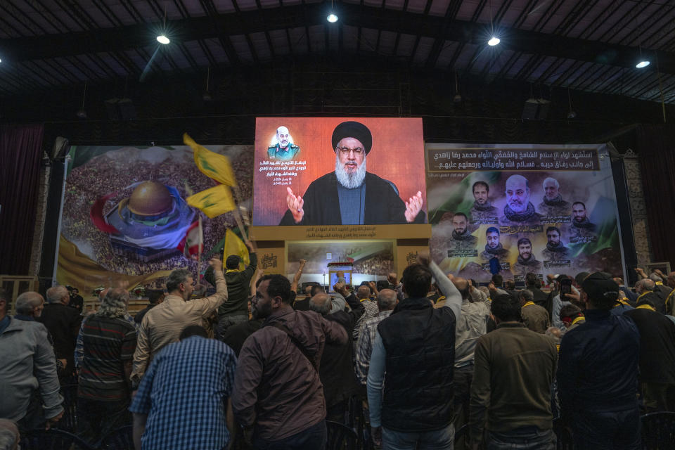 Hezbollah leader Sayyed Hassan Nasrallah speaks in a televised address via a video link during a ceremony to commemorate the death of the Iranian Revolutionary Guard Gen. Mohammad Reza Zahedi, and six officers, who were killed by an Israeli airstrike that demolished Iran's consulate in Syria last Monday, in the southern suburbs of Beirut, Monday, April 8, 2024. Nasrallah paid tribute to Zahedi, who spent 12 years of his career as a top general at the Iranian Revolutionary Guards elite Quds Force with Hezbollah. The Hezbollah leader said he played a key role in strengthening and empowering the group which fought several wars with Israel, and has become Iran's key proxy in the region. (AP Photo/Hassan Ammar)