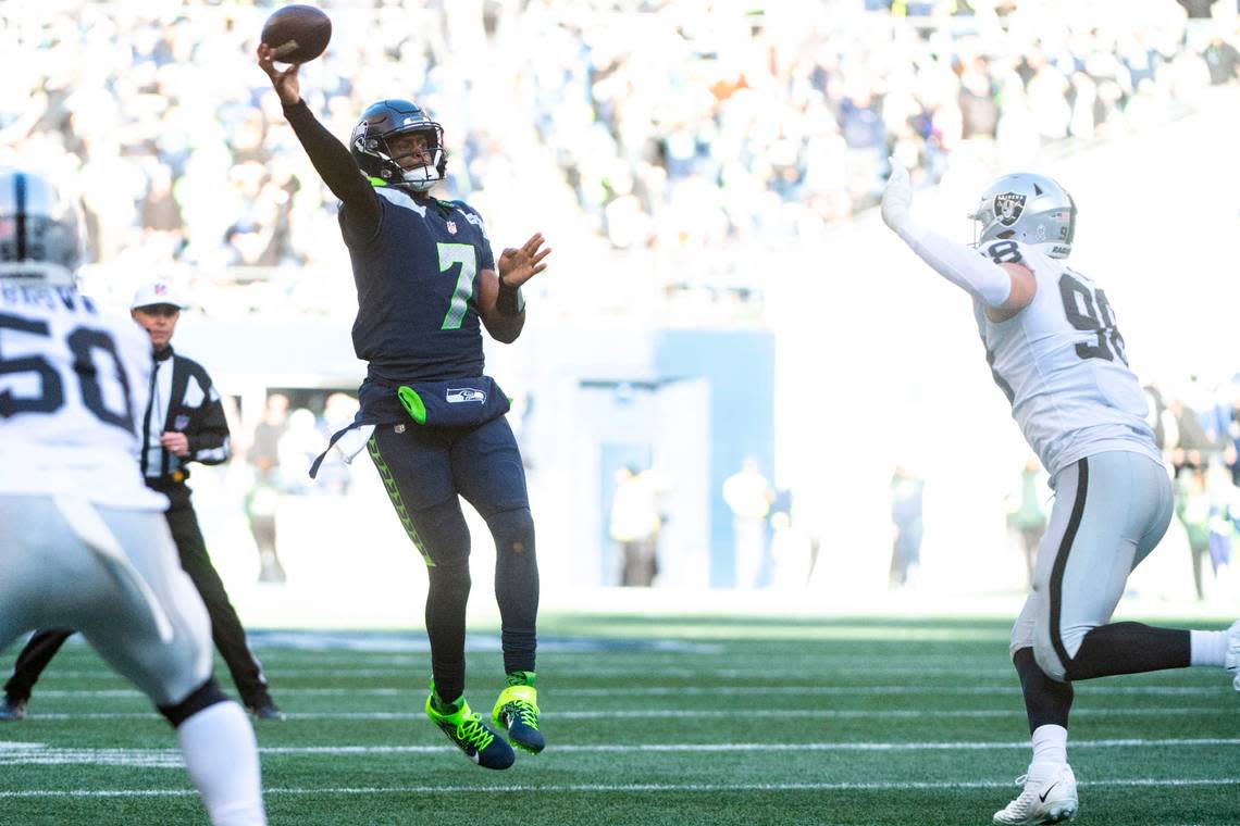 Seattle Seahawks quarterback Geno Smith (7) attempts a pass as Las Vegas Raiders defensive end Maxx Crosby (98) pressures him during the first quarter of an NFL game on Sunday, Nov. 27, 2022, at Lumen Field in Seattle.