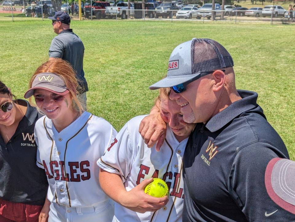 West Valley pitcher Cabria Childers (center) receives the game ball and a hug from coach Willy Church (right) while watched by assistant coach Lexi Kipp (far left) and senior outfielder Cassidy Weaver after leading the Eagles to its first CIF Northern Section softball title since 2008 on Saturday, May 20, 2023.