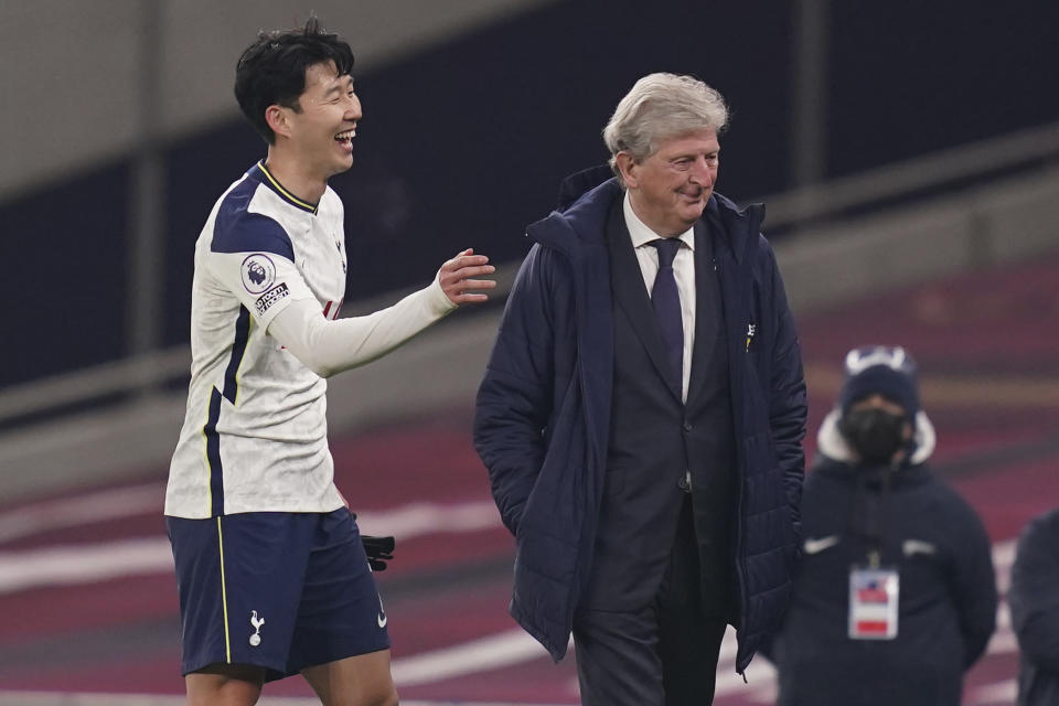 Tottenham's Son Heung-min, left, jokes with Crystal Palace's manager Roy Hodgson during the English Premier League soccer match between Tottenham Hotspur and Crystal Palace at the Tottenham Hotspur Stadium in London, Sunday, March 7, 2021. (John Walton/Pool via AP)