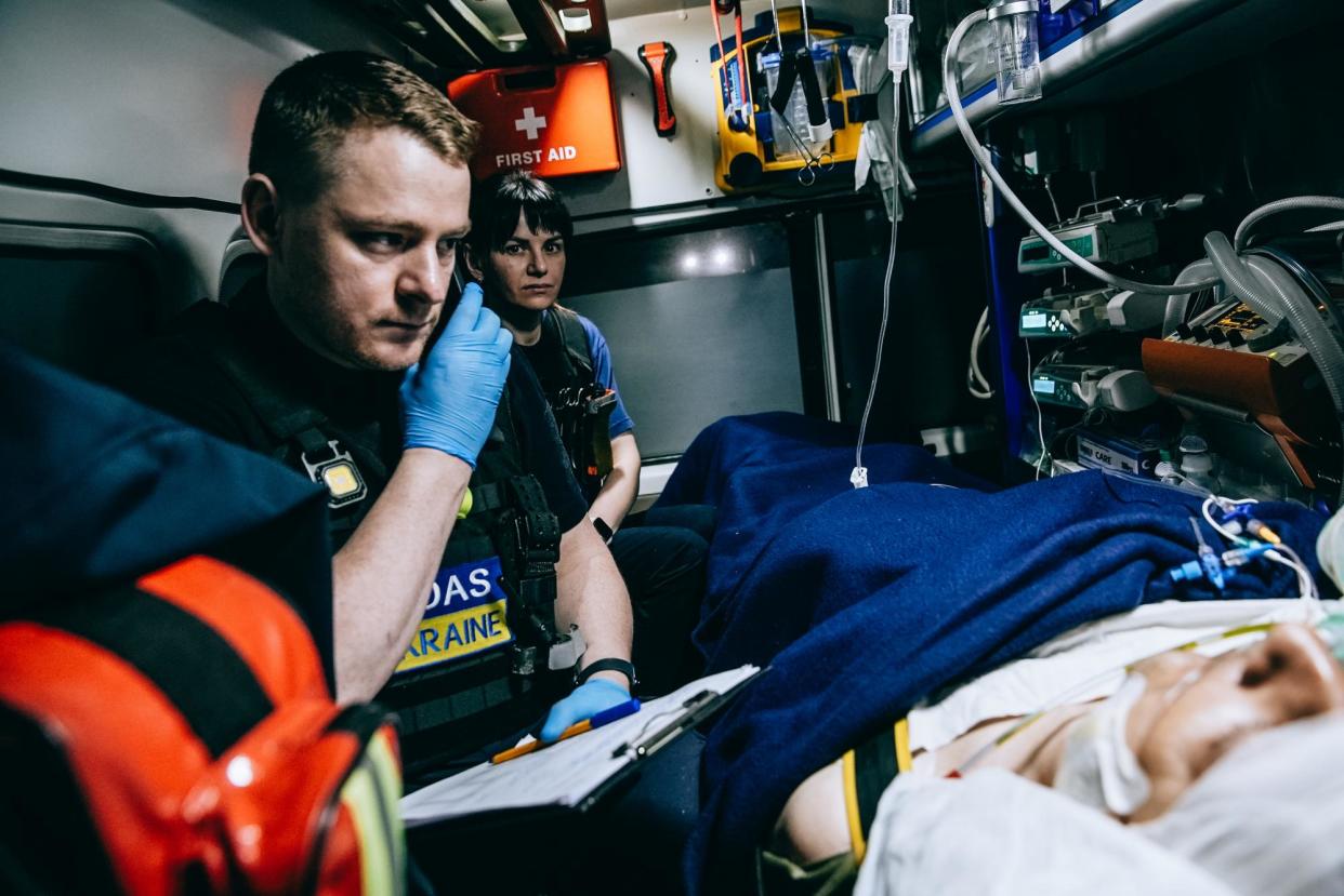 <span>Moas medics with a wounded soldier during a night evacuation which is the only time that staff can go to the front line.</span><span>Photograph: Julia Kochetova/The Guardian</span>