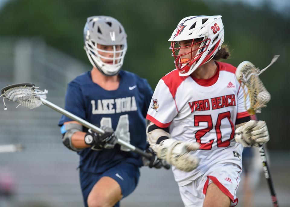 Vero Beach High School's Justin Stolaj Sprints around Riley Murray of Lake Nona during their FHSAA Region 2-2A quarterfinal on Wednesday, April 19, 2023, inside the Citrus Bowl in Vero Beach. Vero won 12-5.