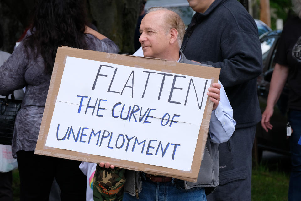 MILFORD, PENNSYLVANIA, UNITED STATES - 2020/05/15: A man holds a placard saying, Flatten the Curve of Unemployment, during the demonstration. Pike County Pennsylvania and Milford, Pennsylvania area residents protest against Governor Wolf and the ongoing business closures. (Photo by Preston Ehrler/SOPA Images/LightRocket via Getty Images)