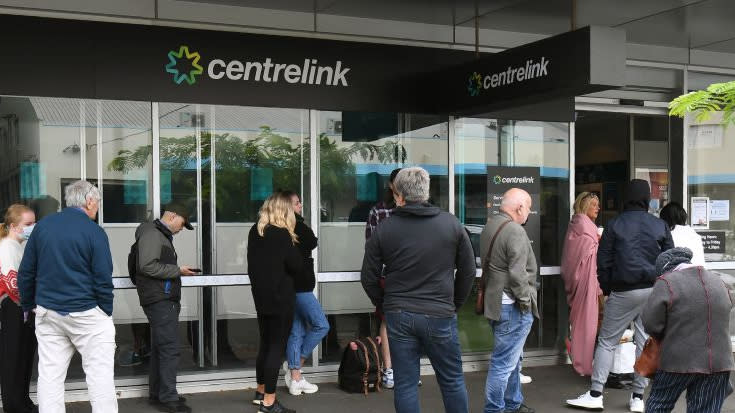 Hundreds of people queue outside an Australian government welfare centre, Centrelink, in Melbourne on March 23, 2020, as jobless Australians flooded unemployment offices around the country after Prime Minister Scott Morrison warned the coronavirus pandemic would cause an economic crisis akin to the Great Depression. (Photo by WILLIAM WEST/AFP via Getty Images)