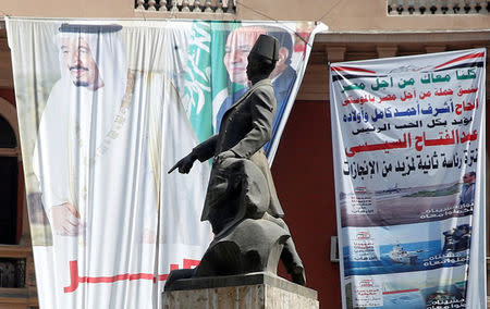 FILE PHOTO: A statue of Egyptian nationalist leader Mustafa Kamel is seen near posters of Egypt's President Abdel Fattah al-Sisi and Saudi Arabia's King Salman bin Abdulaziz al-Saud in Cairo, Egypt March 14, 2018. REUTERS/Amr Abdallah Dalsh