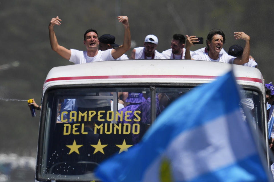 Coach Lionel Scaloni waves during a homecoming parade for the Argentine soccer team that won the World Cup tournament in Buenos Aires, Argentina, Tuesday, Dec. 20, 2022. (AP Photo/Natacha Pisarenko)